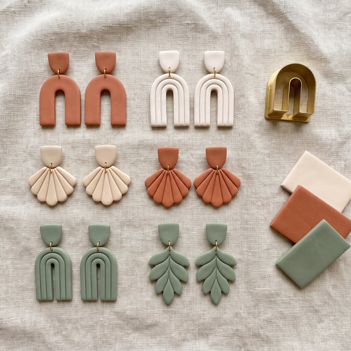Identical polymer clay earring pairs cut with a printed cutter — product render