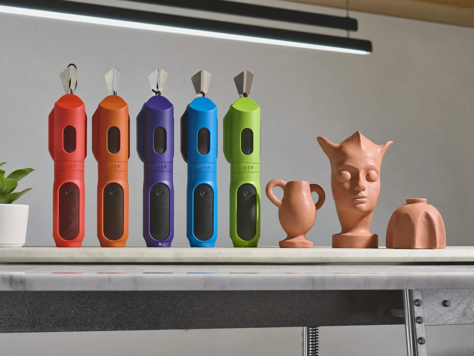 3D-printed cutters beside freshly cut clay shapes.