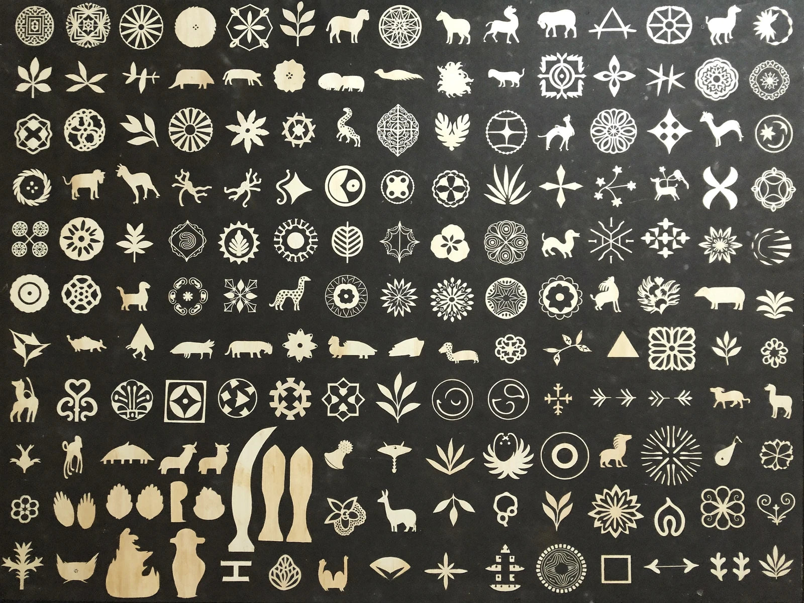 A page of the library: hundreds of clean laser-cut design silhouettes, organized by category